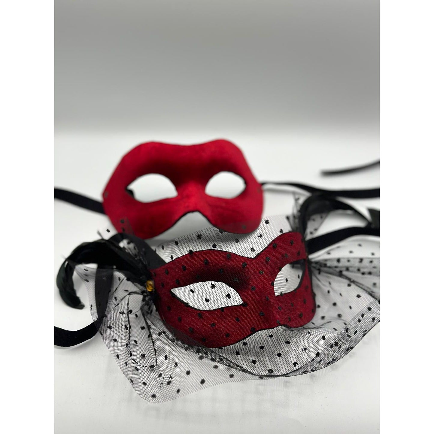Two Venetian ball masks - man and woman mask - in red velvet. Couple mask red